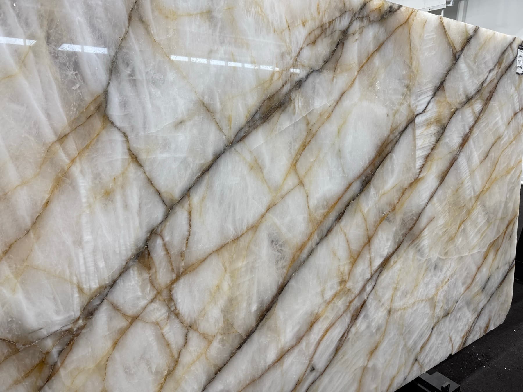 Closer view of the same Cristallo Vitrum slab's crystalline field and gold and charcoal lines
